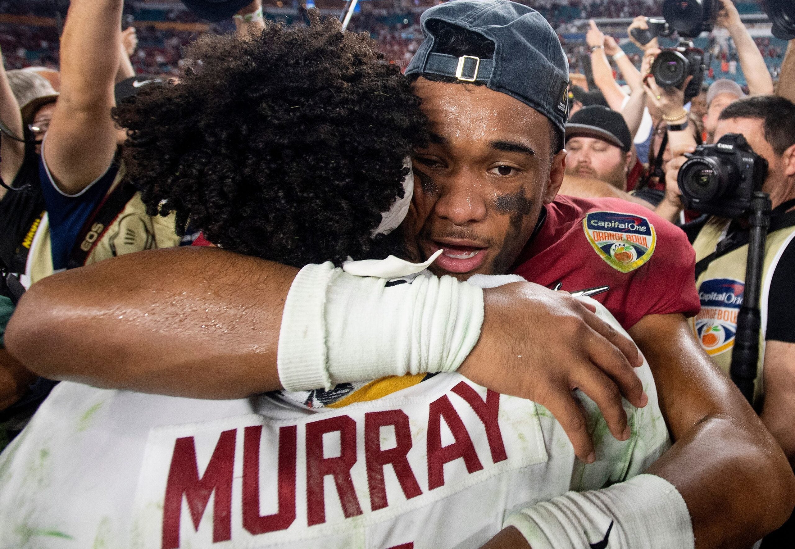 Alabama quarterback Tua Tagovailoa (13) hugs Oklahoma quarterback Kyler Murray (1) following the Orange Bowl at Hard Rock Stadium in Miami Gardens.