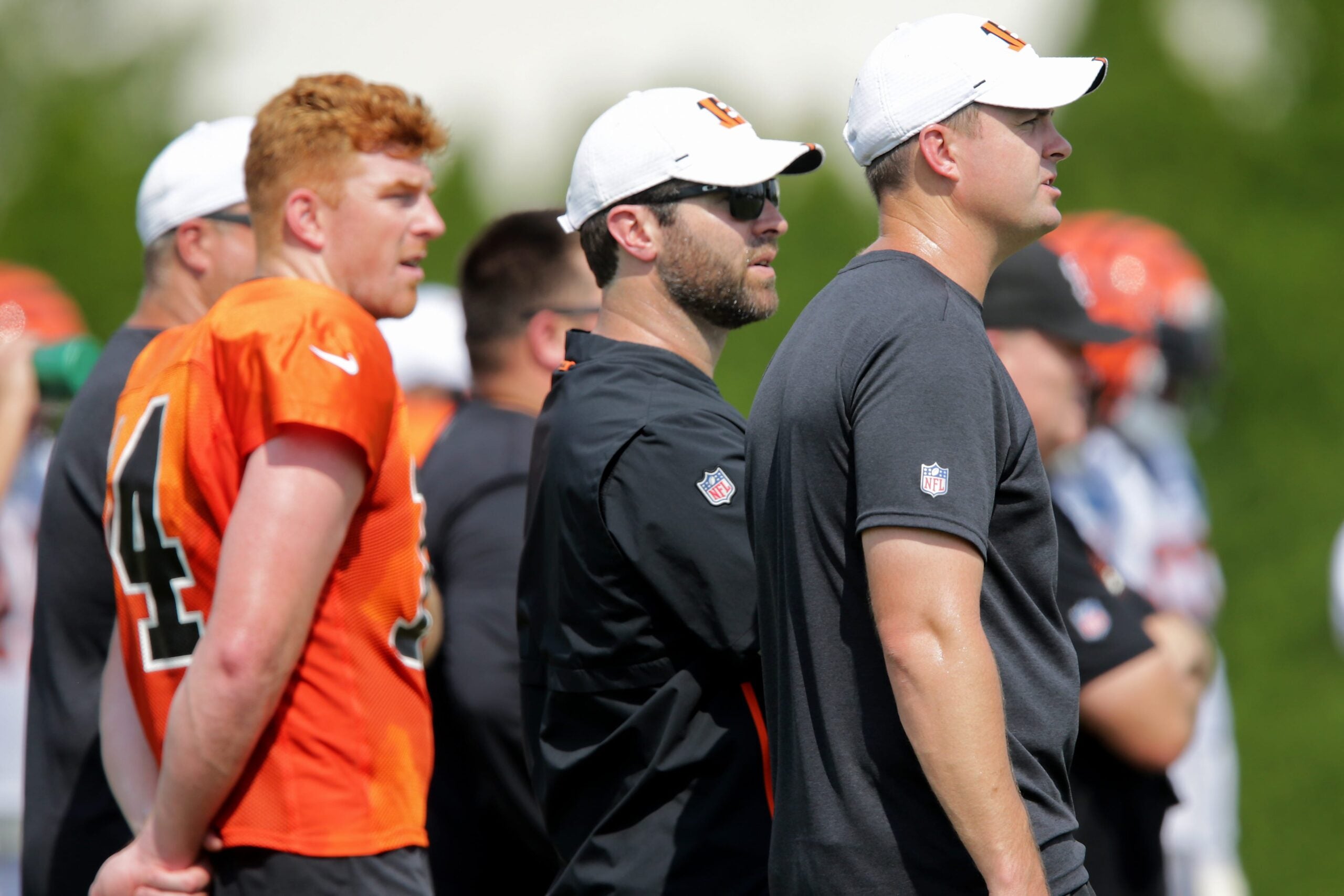 Cincinnati Bengals head coach Zac Taylor, far right, observes practice with Cincinnati Bengals offensive coordinator Brian Callahan and Cincinnati Bengals quarterback Andy Dalton (14) during Cincinnati Bengals training camp practice, Wednesday, July 31, 2019, at the practice fields next to Paul Brown Stadium in Cincinnati.