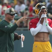 Green Bay Packers quarterback Jordan Love (10) is shown with quarterbacks coach Luke Getsy during the first day of training camp Wednesday, July 28, 2021 in Green Bay, Wis.