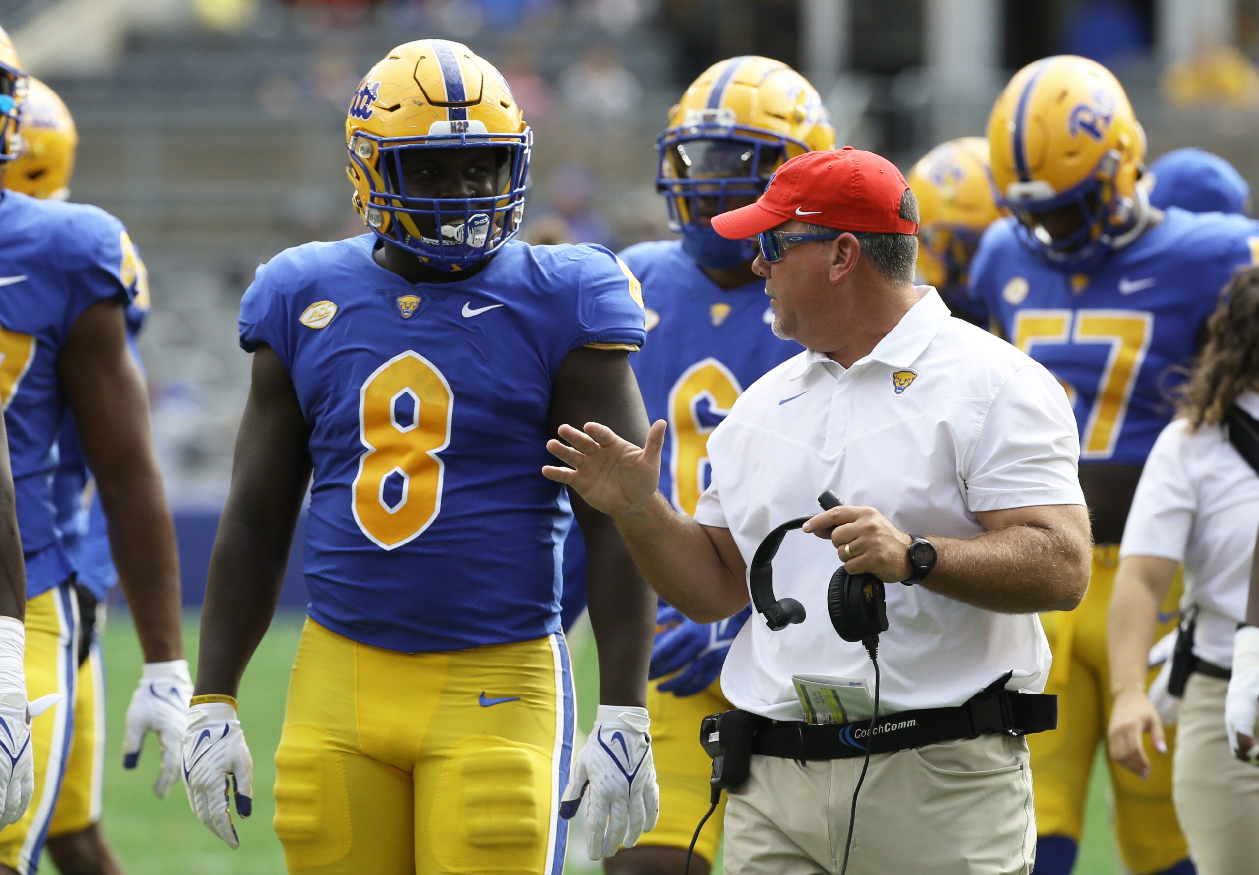 Sep 25, 2021; Pittsburgh, Pennsylvania, USA; Pittsburgh Panthers assistant head coach Charlie Partridge (right) talks with defensive lineman Calijah Kancey (8) against the New Hampshire Wildcats during the first quarter at Heinz Field. Mandatory Credit: Charles LeClaire-USA TODAY Sports