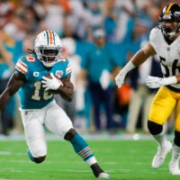 Oct 23, 2022; Miami Gardens, Florida, USA; Miami Dolphins wide receiver Tyreek Hill (10) runs with the football ahead of Pittsburgh Steelers linebacker Alex Highsmith (56) during the first quarter at Hard Rock Stadium.