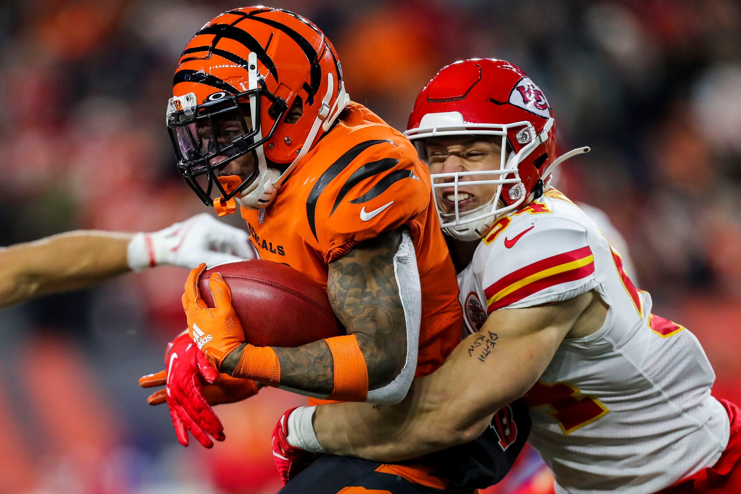 Dec 4, 2022; Cincinnati, Ohio, USA; Cincinnati Bengals running back Trayveon Williams (32) returns the ball on a kick off against Kansas City Chiefs linebacker Leo Chenal (54) in the first half at Paycor Stadium.