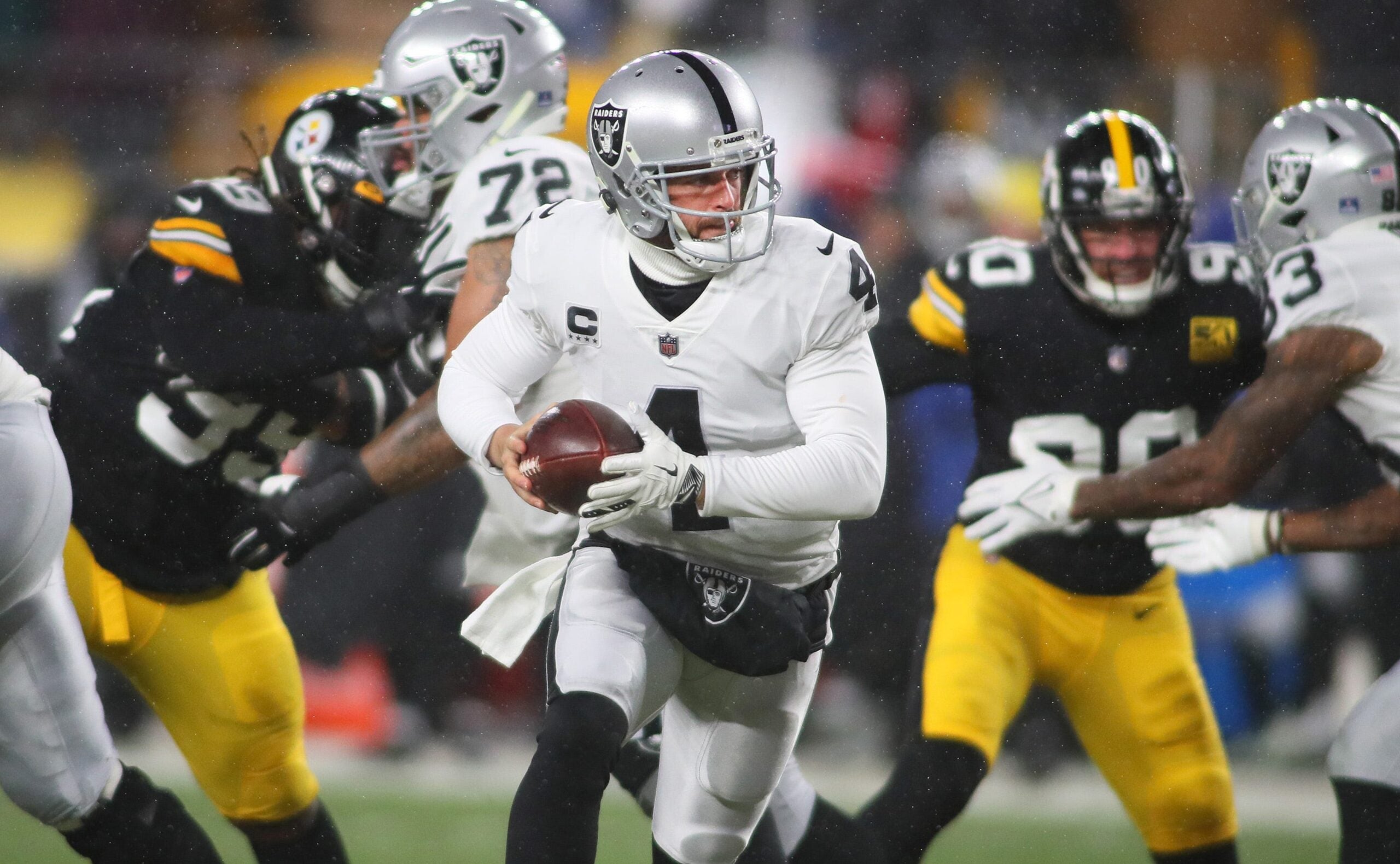 as Vegas Raiders Derek Carr (4) prepares to hand the ball off during the first half against the Pittsburgh Steelers at Acrisure Stadium in Pittsburgh, PA on December 24, 2022. Pittsburgh Steelers Vs Las Vegas Raiders Week 16