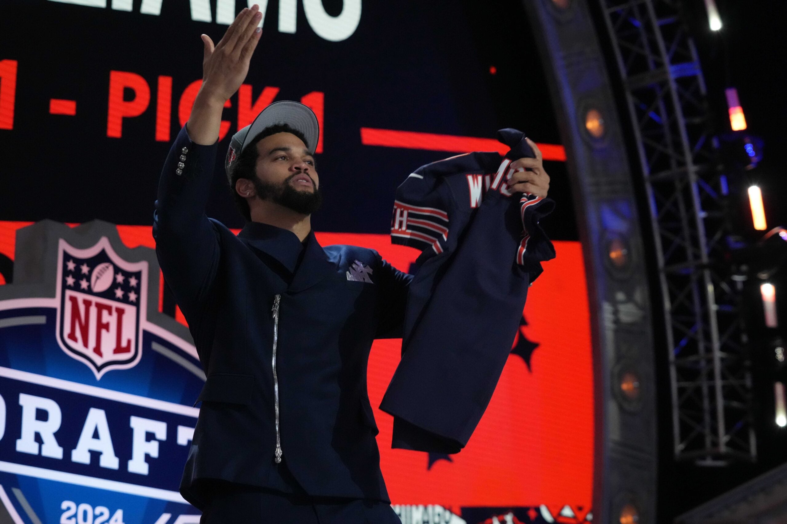 Apr 25, 2024; Detroit, MI, USA; Southern California Trojans quarterback Caleb Williams poses with jersey after being chosen as the No. 1 pick in the first round during the 2024 NFL Draft at Campus Martius Park and Hart Plaza.