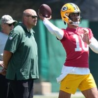 As Green Bay Packers offensive coordinator Adam Stenavich looks on, quarterback Jordan Love (10) throws a pass during organized team activities Wednesday, May 29, 2024 in Green Bay, Wisconsin.