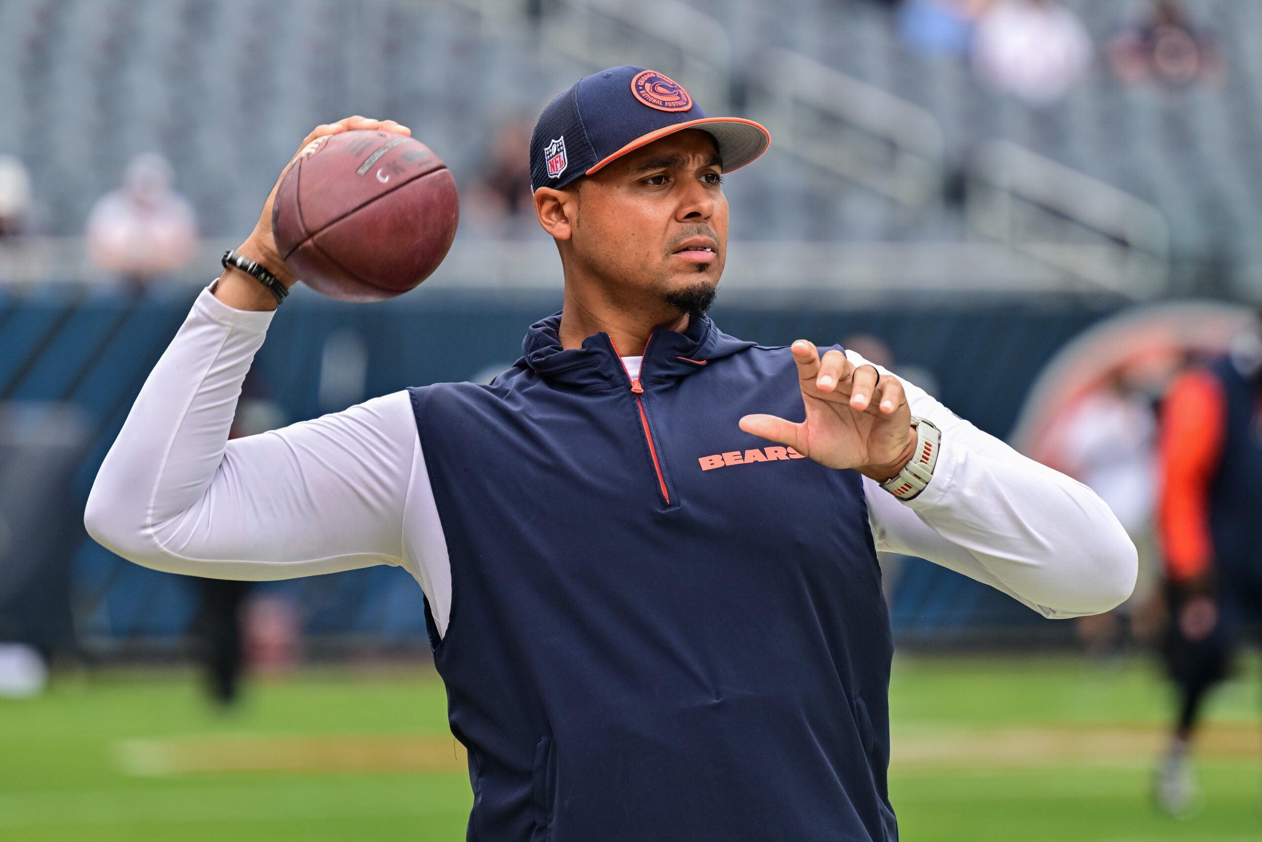 Aug 17, 2024; Chicago, Illinois, USA; Chicago Bears general manager Ryan Poles plays catch on the sideline before the game against the Cincinnati Bengals at Soldier Field.