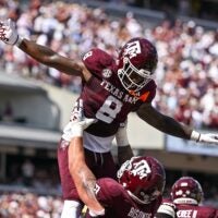 Oct 5, 2024; College Station, Texas, USA; Texas A&M Aggies running back Le'Veon Moss (8) celebrates with offensive lineman Chase Bisontis (71) after scoring a touchdown in the second quarter against the Missouri Tigers at Kyle Field. Mandatory Credit: Maria Lysaker-Imagn Images.