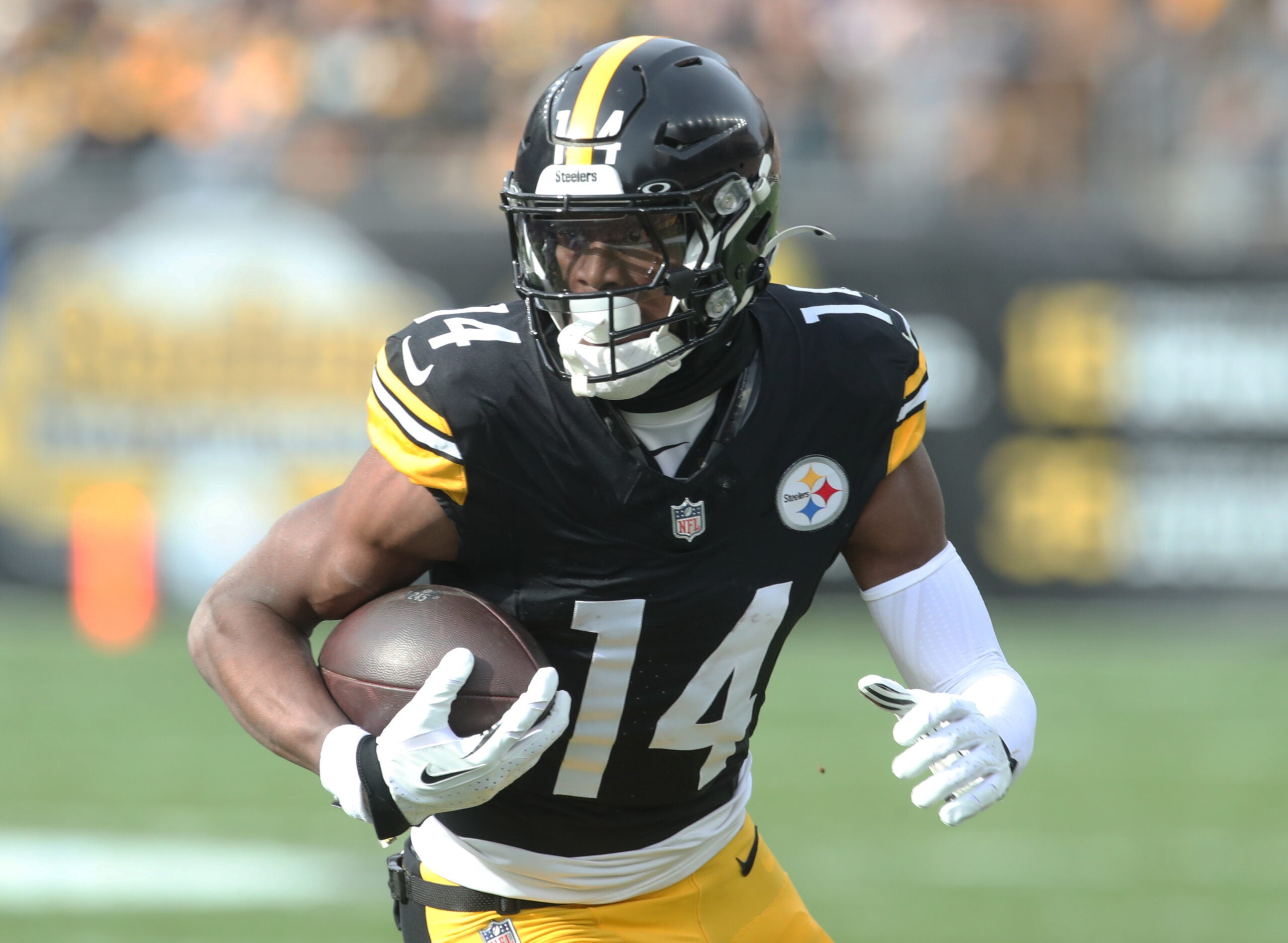 Nov 17, 2024; Pittsburgh, Pennsylvania, USA; Pittsburgh Steelers wide receiver George Pickens (14) runs after a catch against the Baltimore Ravens during the first quarter at Acrisure Stadium.
