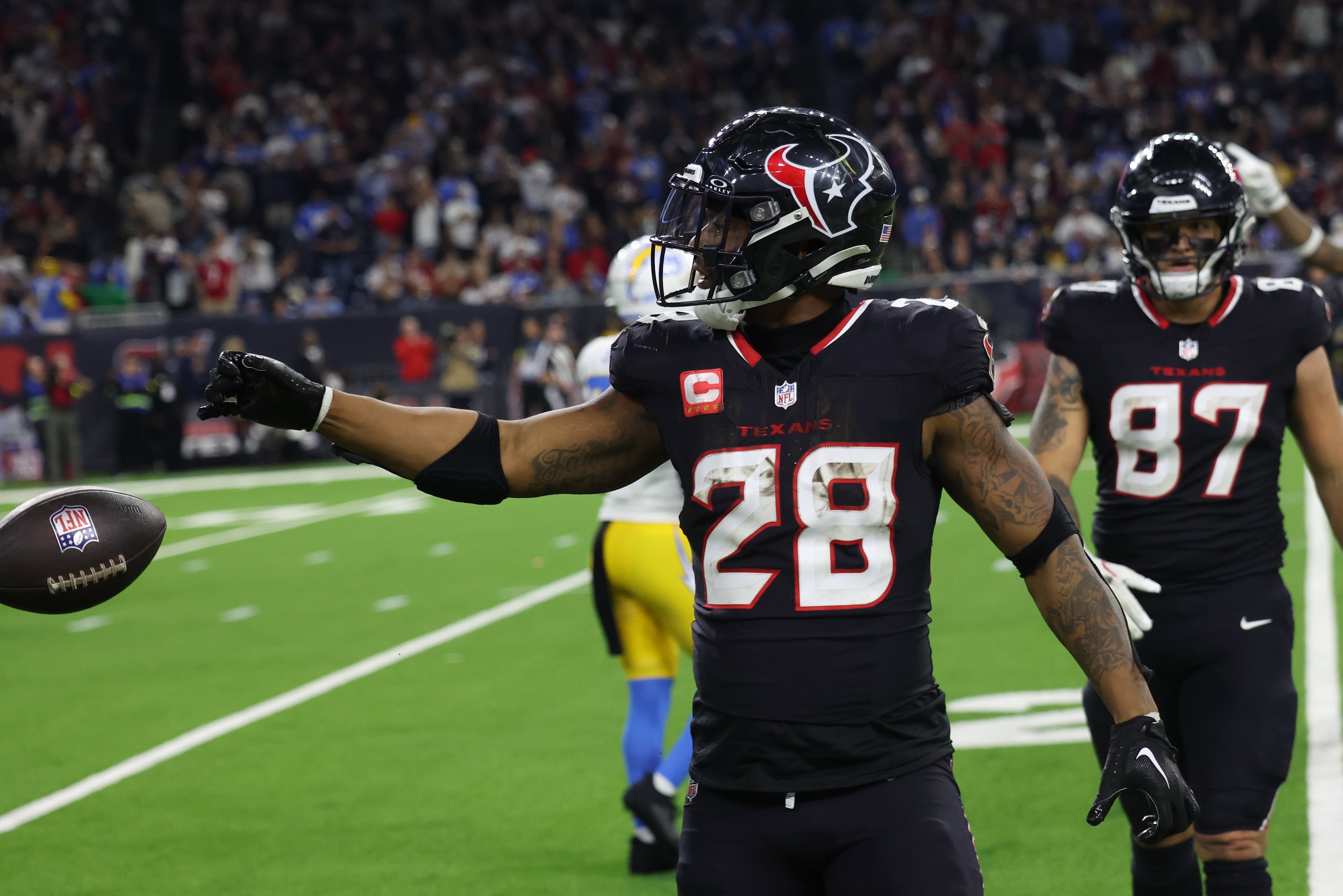 Jan 11, 2025; Houston, Texas, USA; Houston Texans running back Joe Mixon (28) reacts to his rushing first down against the Los Angeles Chargers in the fourth quarter in an AFC wild card game at NRG Stadium.