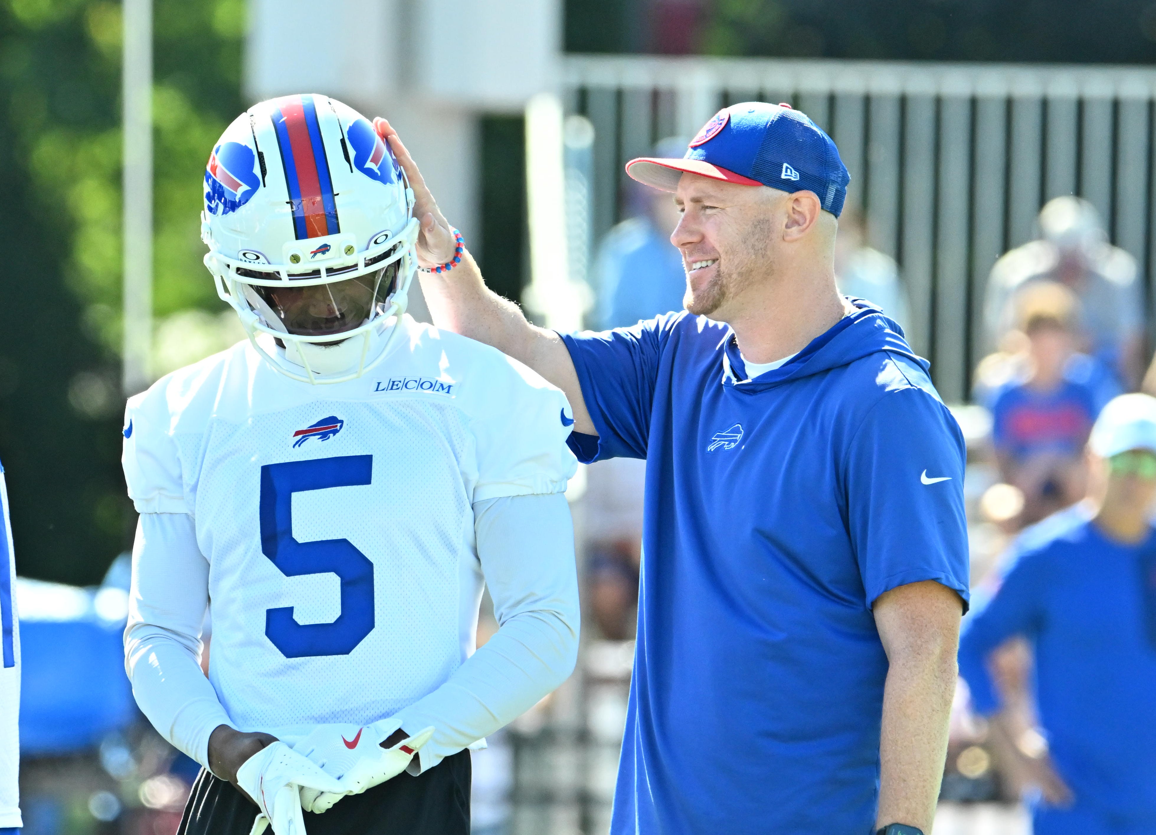 Jul 23, 2025; Rochester, NY, USA; Buffalo Bills offensive coordinator Joe Brady pats wide receiver Joshua Palmer (5)during training camp at St. John Fisher University.