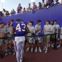 Buffalo Bills Dorian Strong stops to sign an autograph for a high school football player whose team was lined up in the tunnel to the field. Players signed autographs for fans and hung out with their family after the Return of the Blue & Red practice at Highmark Stadium in Orchard Park on Aug.1, 2025.