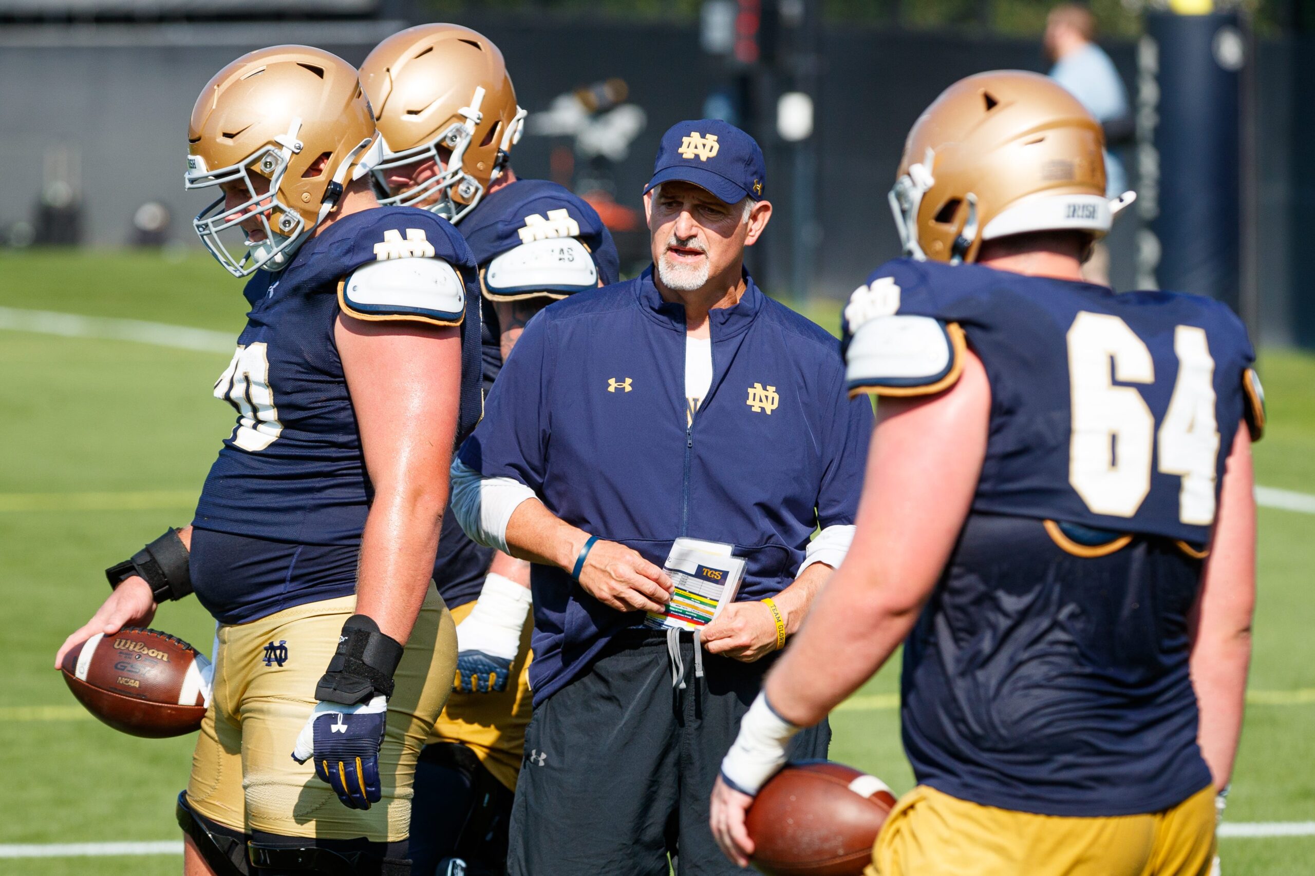 Notre Dame offensive line coach Joe Rudolph, center, leads a drill during a football practice at Irish Athletic Center on Wednesday, Aug. 6, 2025, in South Bend.