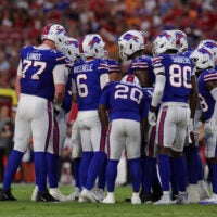Aug 23, 2025; Tampa, Florida, USA; Buffalo Bills quarterback Shane Buechele (6) leads a huddle against the Tampa Bay Buccaneers in the first quarter at Raymond James Stadium.