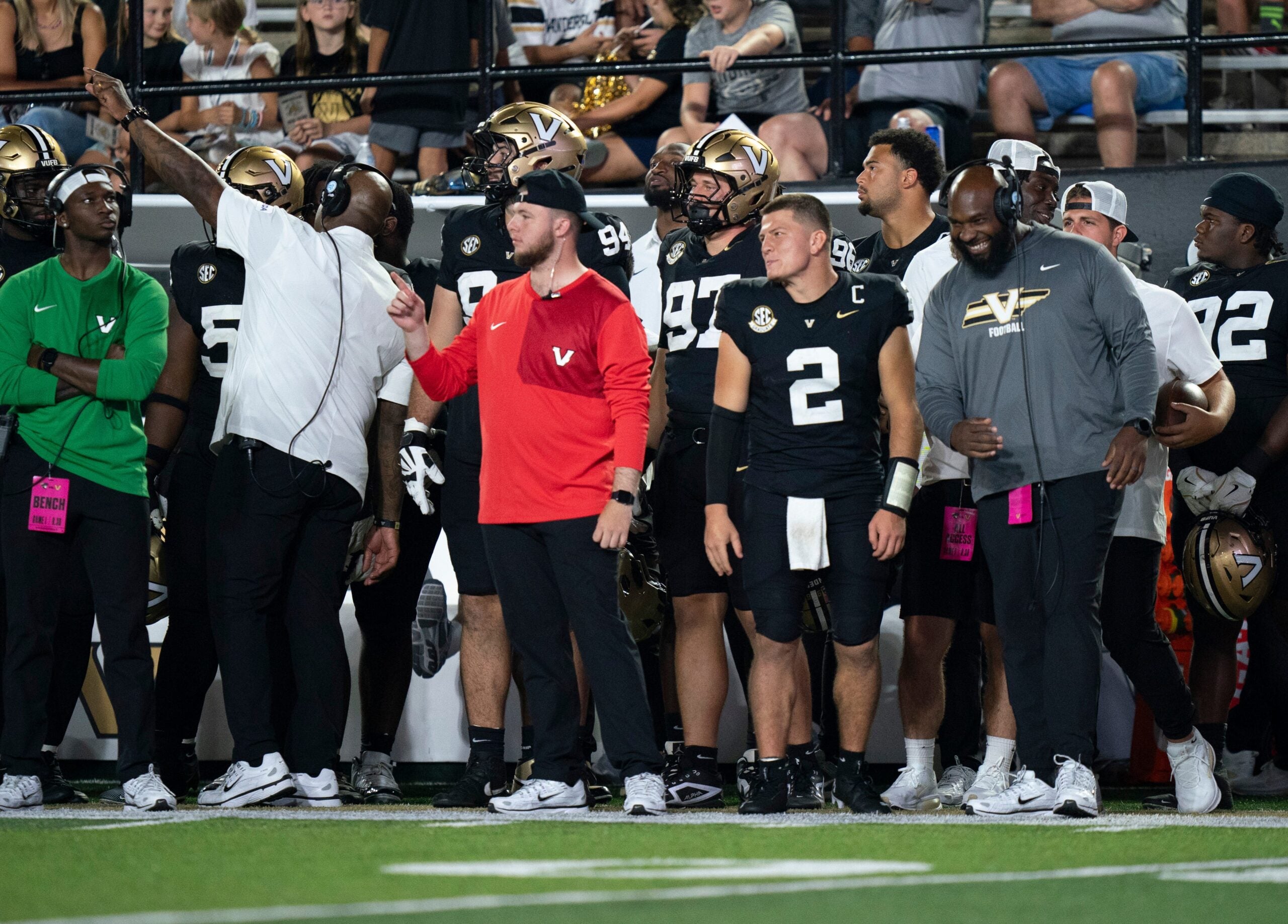 Vanderbilt quarterback Diego Pavia (2) and Vanderbilt defensive line coach Larry Black, far right, have a laugh late in the second half of their game at FirstBank Stadium in Nashville, Tenn., Saturday, Aug. 30, 2025.