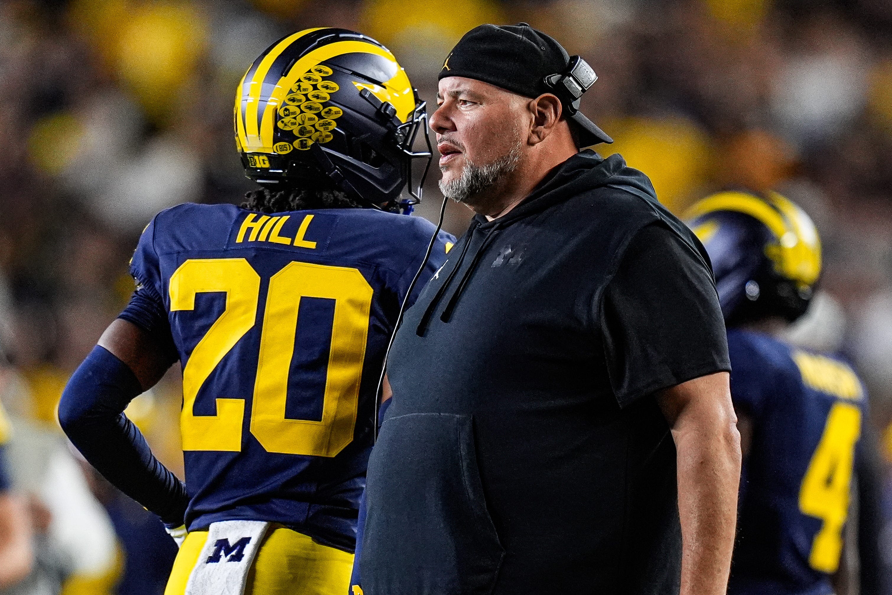 Michigan defensive line coach Lou Esposito talks to players after a play against New Mexicoduring the first half at Michigan Stadium in Ann Arbor on Saturday, August 30, 2025.