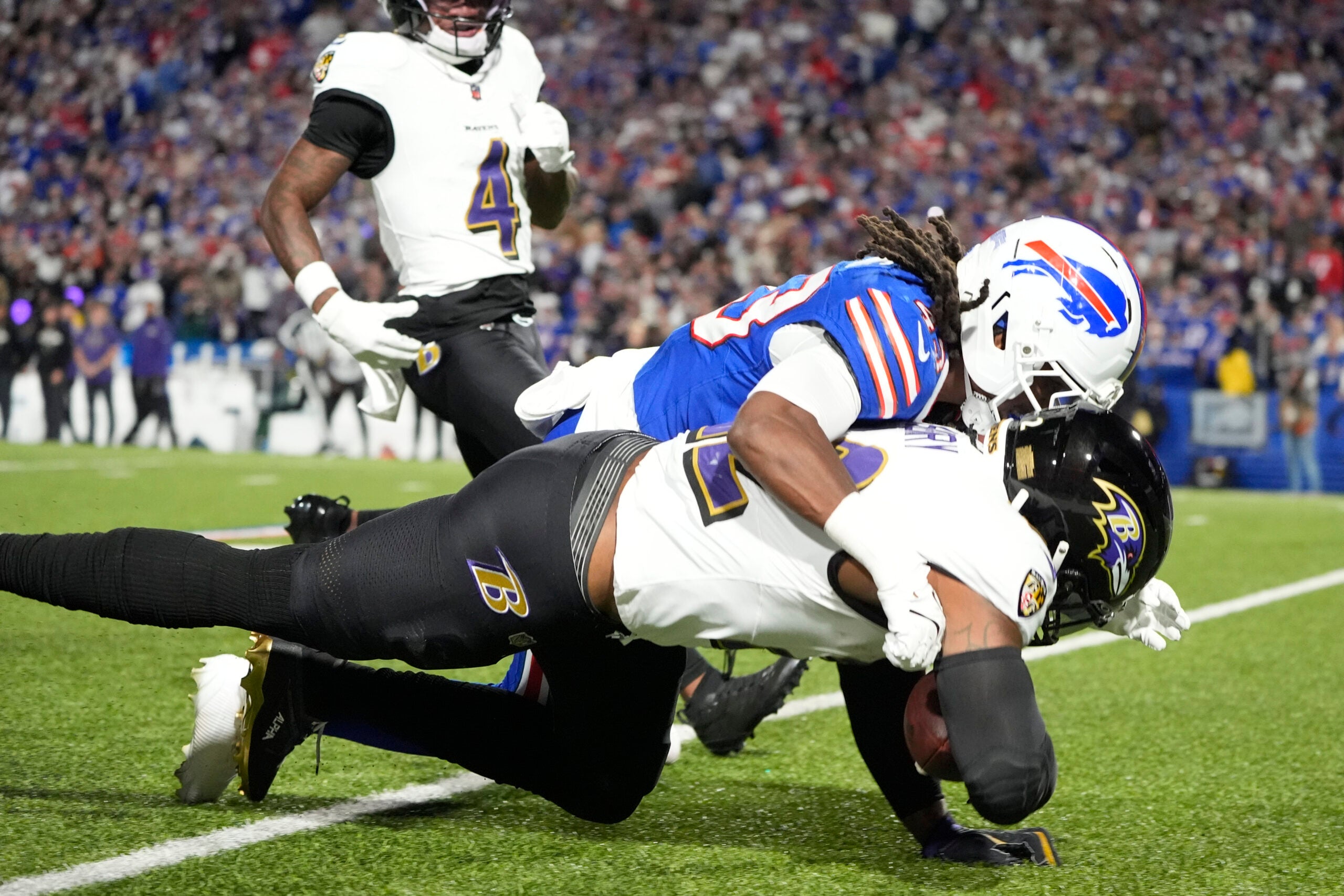 Sep 7, 2025; Orchard Park, New York, USA; Baltimore Ravens running back Derrick Henry (22) runs the ball during the second quarter against Buffalo Bills cornerback Dorian Strong (43) at Highmark Stadium.