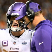 Sep 8, 2025; Chicago, Illinois, USA; Minnesota Vikings head coach Kevin O'Connell talks with quarterback J.J. McCarthy (9) during the first half at Soldier Field.