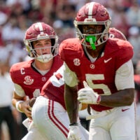 Sep 13, 2025; Tuscaloosa, Alabama, USA; Alabama quarterback Ty Simpson (15) makes a play action fake before throwing to Alabama wide receiver Germie Bernard (5) during the game with Wisconsin at Saban Field at Bryant-Denny Stadium.