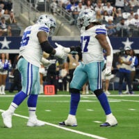 Sep 14, 2025; Arlington, Texas, USA; Dallas Cowboys defensive tackle Kenny Clark (95) and defensive tackle Osa Odighizuwa (97) react after a sack against the New York Giants at AT&T Stadium.