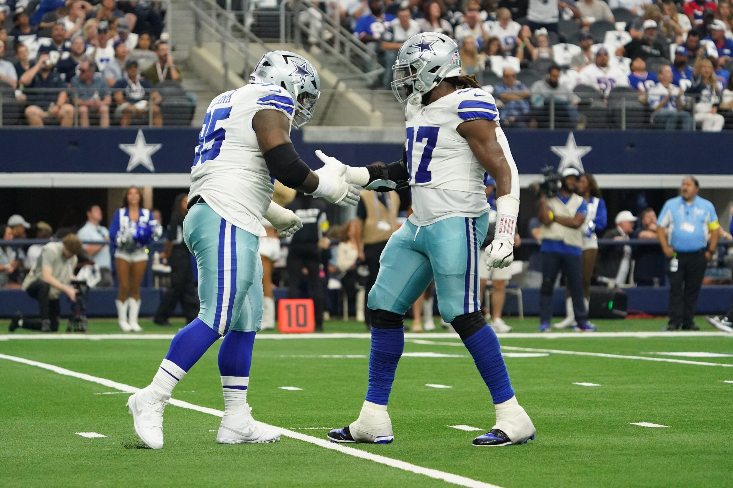 Sep 14, 2025; Arlington, Texas, USA; Dallas Cowboys defensive tackle Kenny Clark (95) and defensive tackle Osa Odighizuwa (97) react after a sack against the New York Giants at AT&T Stadium.