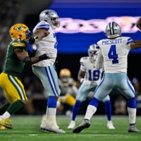 Sep 28, 2025; Arlington, Texas, USA; Dallas Cowboys guard Tyler Smith (73) blocks Green Bay Packers defensive end Micah Parsons (1) as quarterback Dak Prescott (4) throws the ball during the game between the Dallas Cowboys and the Green Bay Packers at AT&T Stadium.