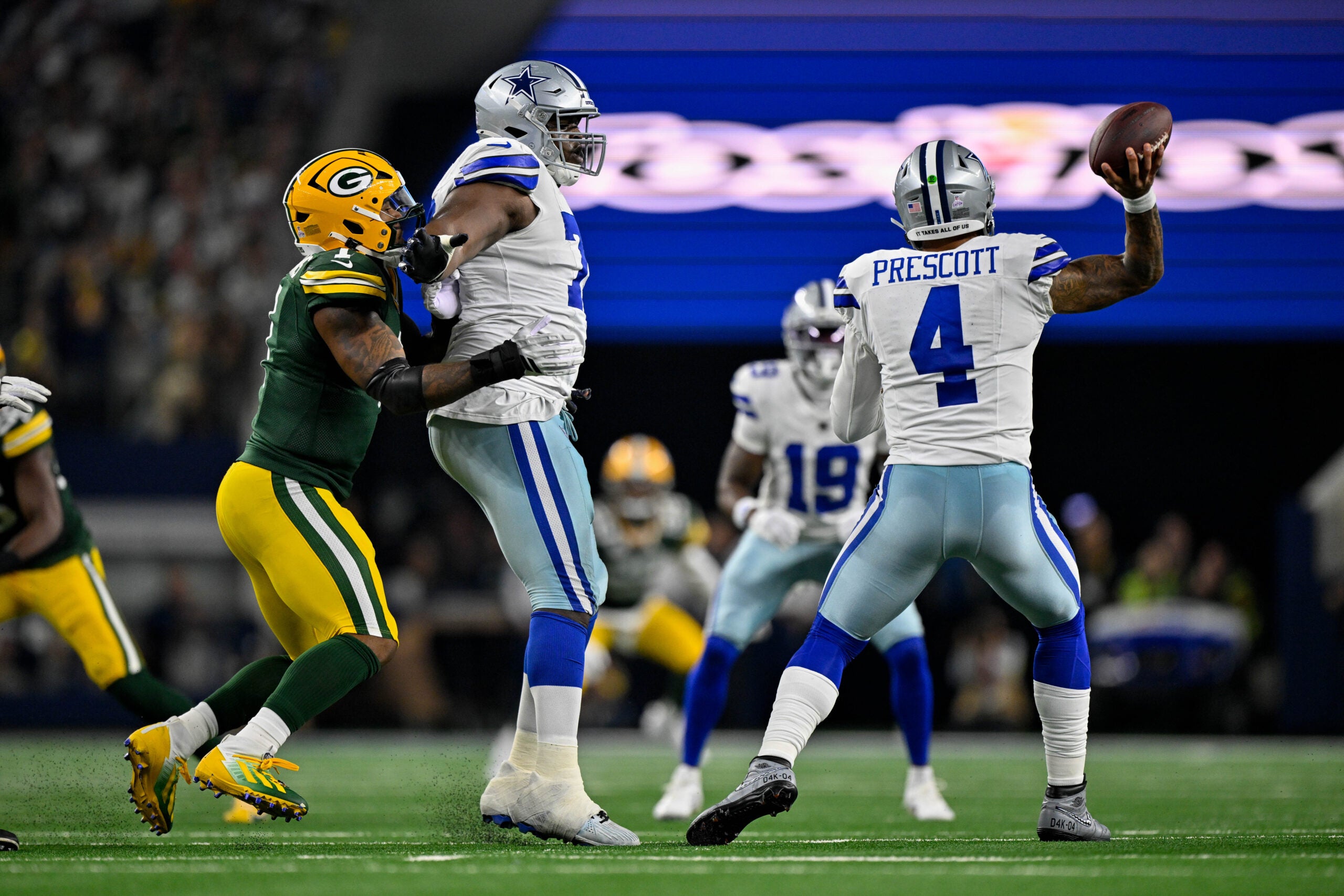 Sep 28, 2025; Arlington, Texas, USA; Dallas Cowboys guard Tyler Smith (73) blocks Green Bay Packers defensive end Micah Parsons (1) as quarterback Dak Prescott (4) throws the ball during the game between the Dallas Cowboys and the Green Bay Packers at AT&T Stadium.