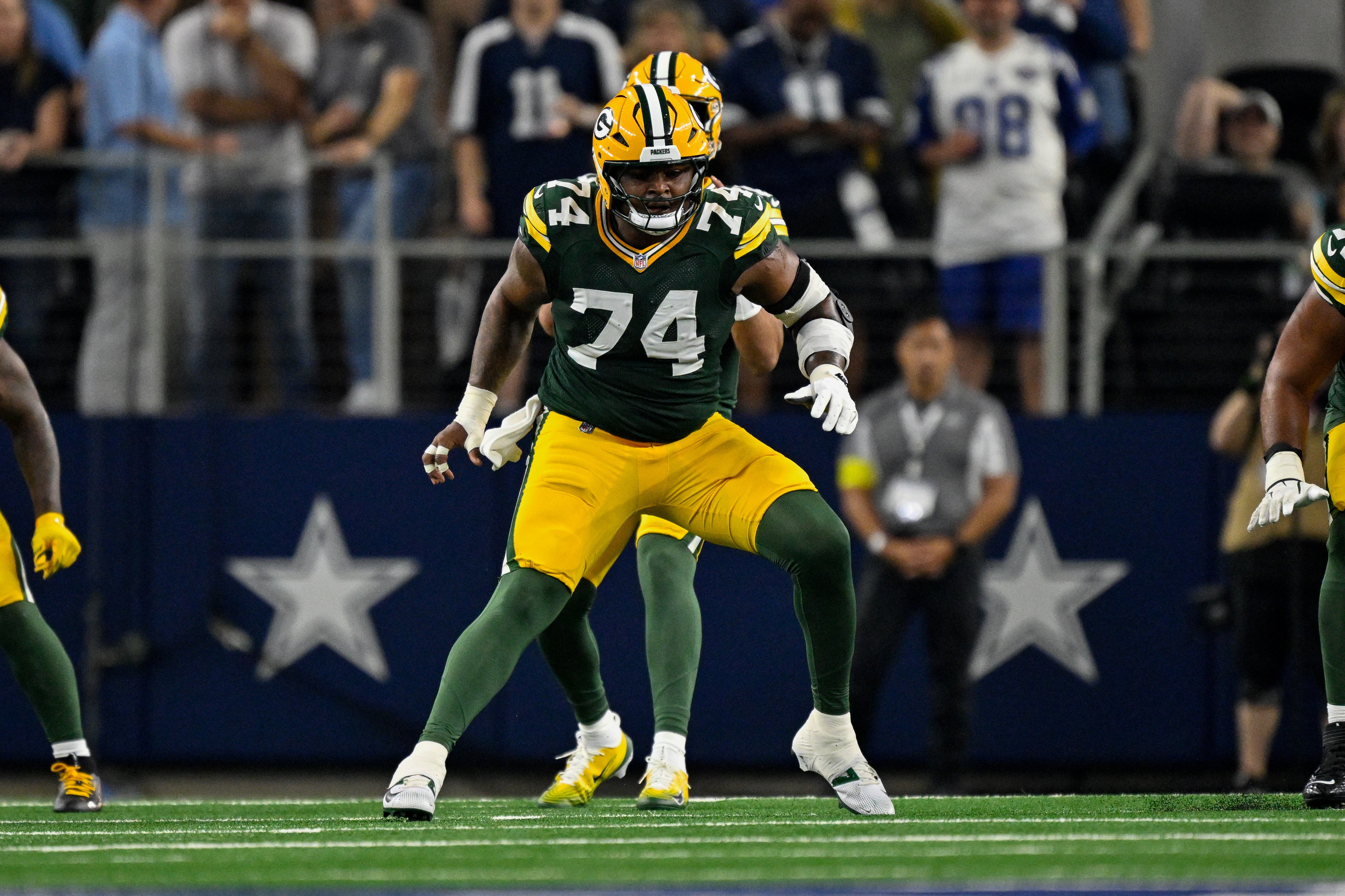 Sep 28, 2025; Arlington, Texas, USA; Green Bay Packers guard Elgton Jenkins (74) blocks against the Dallas Cowboys during the game between the Dallas Cowboys and the Green Bay Packers at AT&T Stadium.