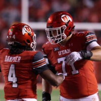 Oct 11, 2025; Salt Lake City, Utah, USA; Utah Utes quarterback Devon Dampier (4) celebrates scoring a touchdown against the Arizona State Sun Devils with Utah Utes offensive lineman Caleb Lomu (71) during the second quarter at Rice-Eccles Stadium. Mandatory Credit: Rob Gray-Imagn Images