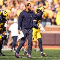 Michigan defensive backs coach LaMar Morgan reacts to a play against Washington during the second half at Michigan Stadium in Ann Arbor on Saturday, Oct. 18, 2025.