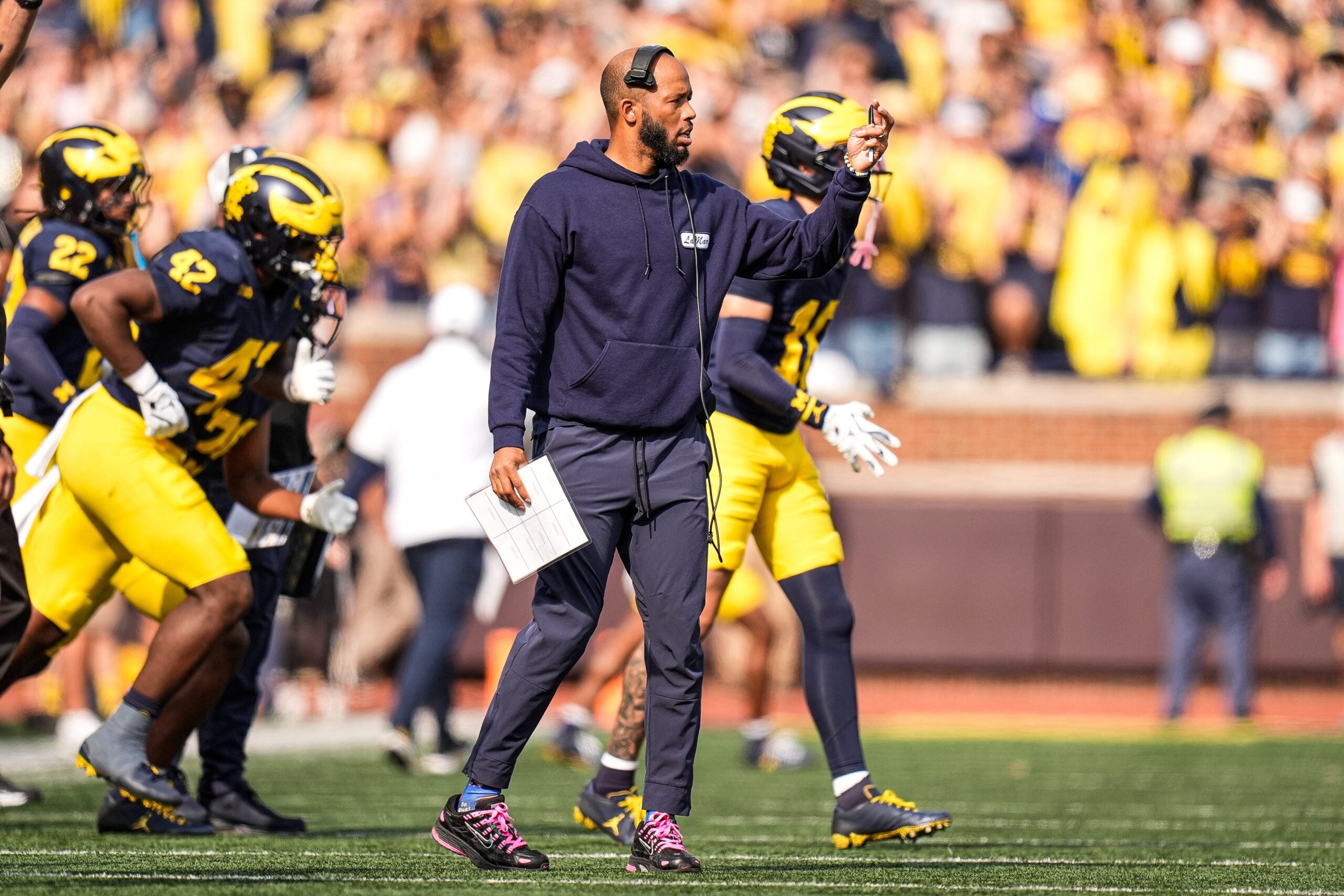 Michigan defensive backs coach LaMar Morgan reacts to a play against Washington during the second half at Michigan Stadium in Ann Arbor on Saturday, Oct. 18, 2025.
