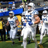 Colts players run out of the tunnel to take on the Chargers