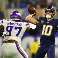 Oct 23, 2025; Inglewood, California, USA; Minnesota Vikings defensive tackle Javon Hargrave (97) gets pressure on Los Angeles Chargers quarterback Justin Herbert (10) during the first half at SoFi Stadium.
