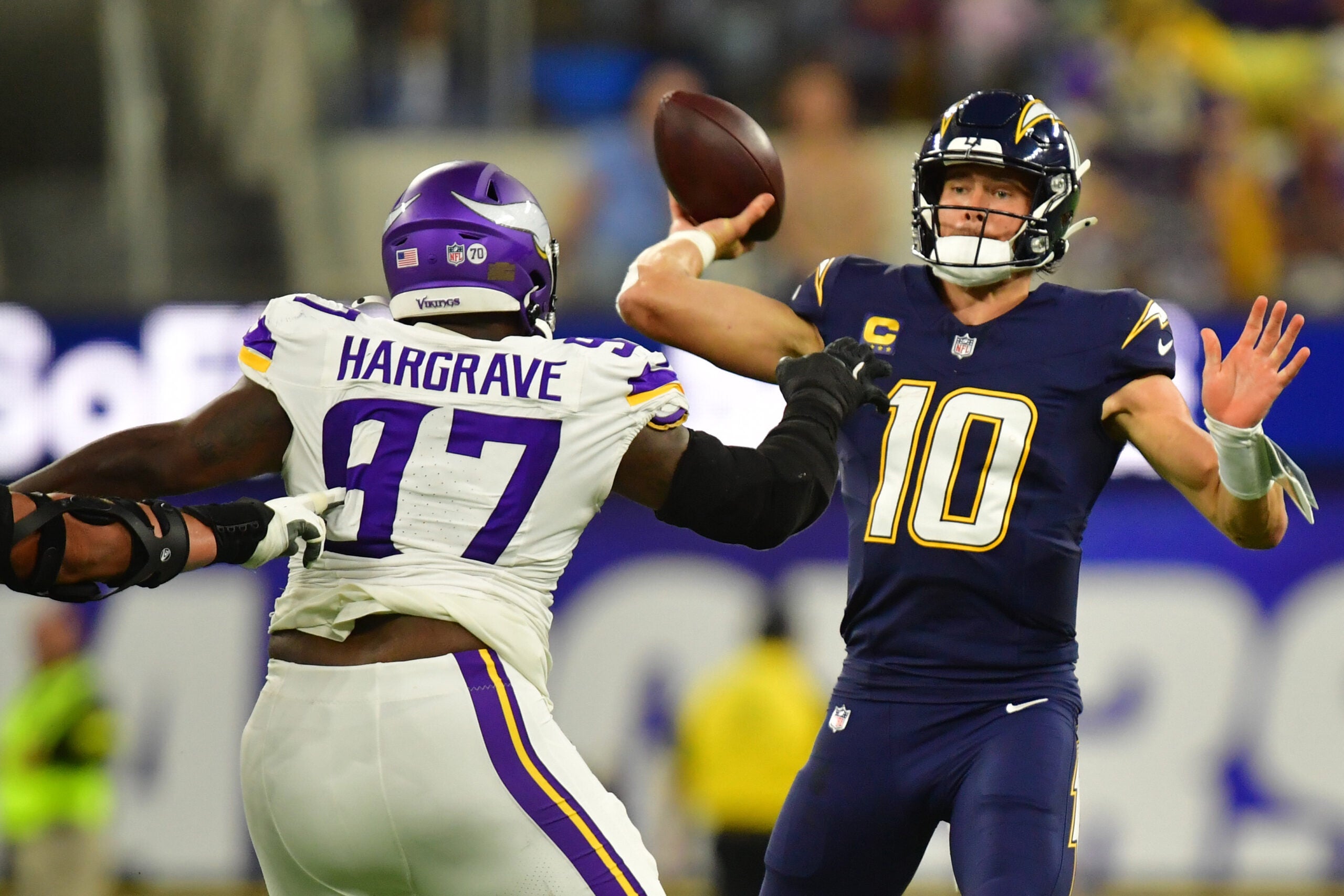 Oct 23, 2025; Inglewood, California, USA; Minnesota Vikings defensive tackle Javon Hargrave (97) gets pressure on Los Angeles Chargers quarterback Justin Herbert (10) during the first half at SoFi Stadium.