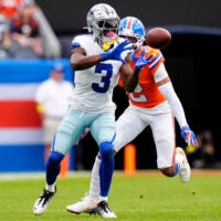 Oct 26, 2025; Denver, Colorado, USA; Dallas Cowboys wide receiver George Pickens (3) makes a catch against Denver Broncos cornerback Pat Surtain II (2) in the second quarter at Empower Field at Mile High.