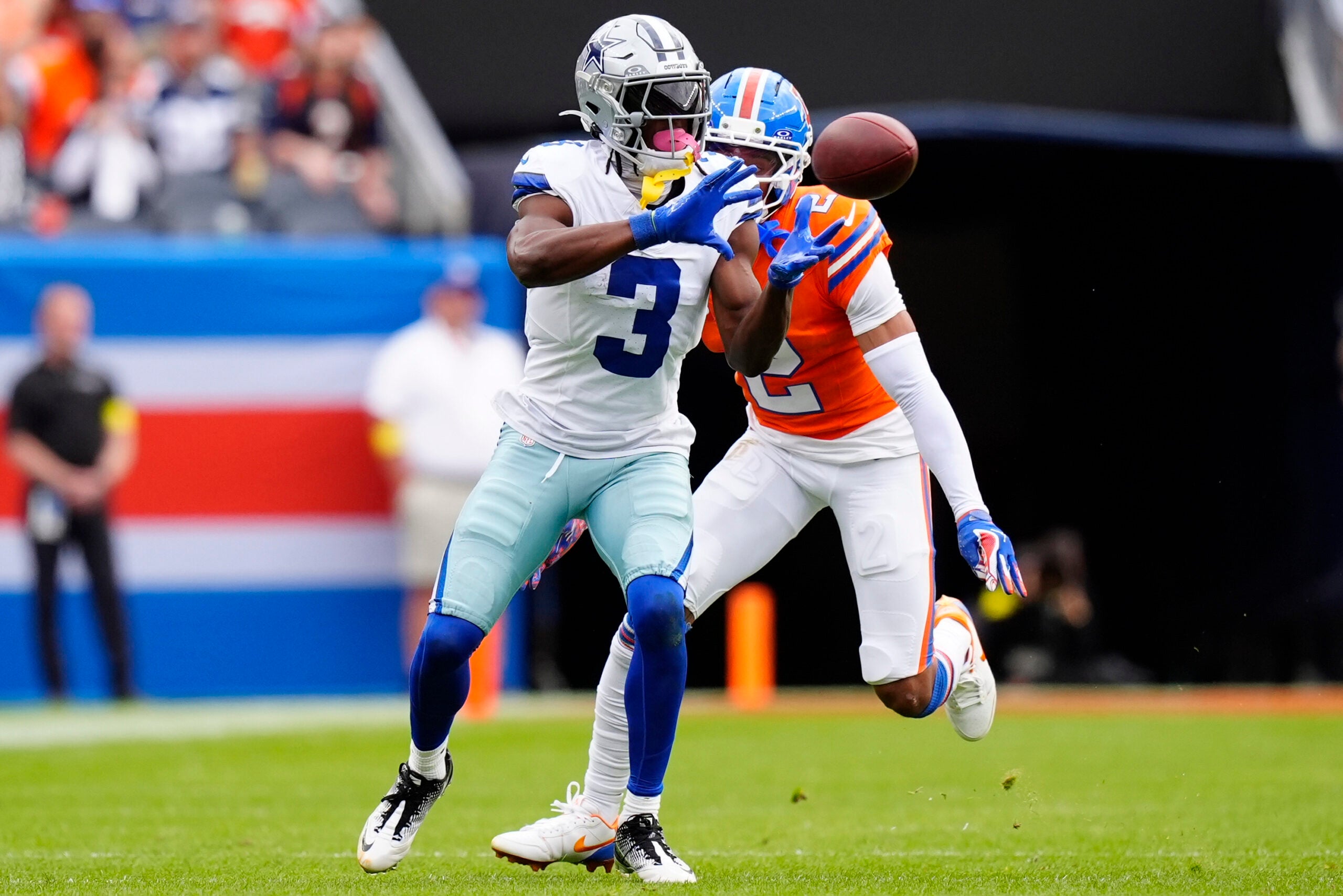 Oct 26, 2025; Denver, Colorado, USA; Dallas Cowboys wide receiver George Pickens (3) makes a catch against Denver Broncos cornerback Pat Surtain II (2) in the second quarter at Empower Field at Mile High.