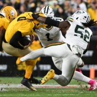 Oct 26, 2025; Pittsburgh, Pennsylvania, USA; Pittsburgh Steelers quarterback Aaron Rodgers (8) is sacked by Green Bay Packers defensive end Rashan Gary (52) during the first quarter at Acrisure Stadium.