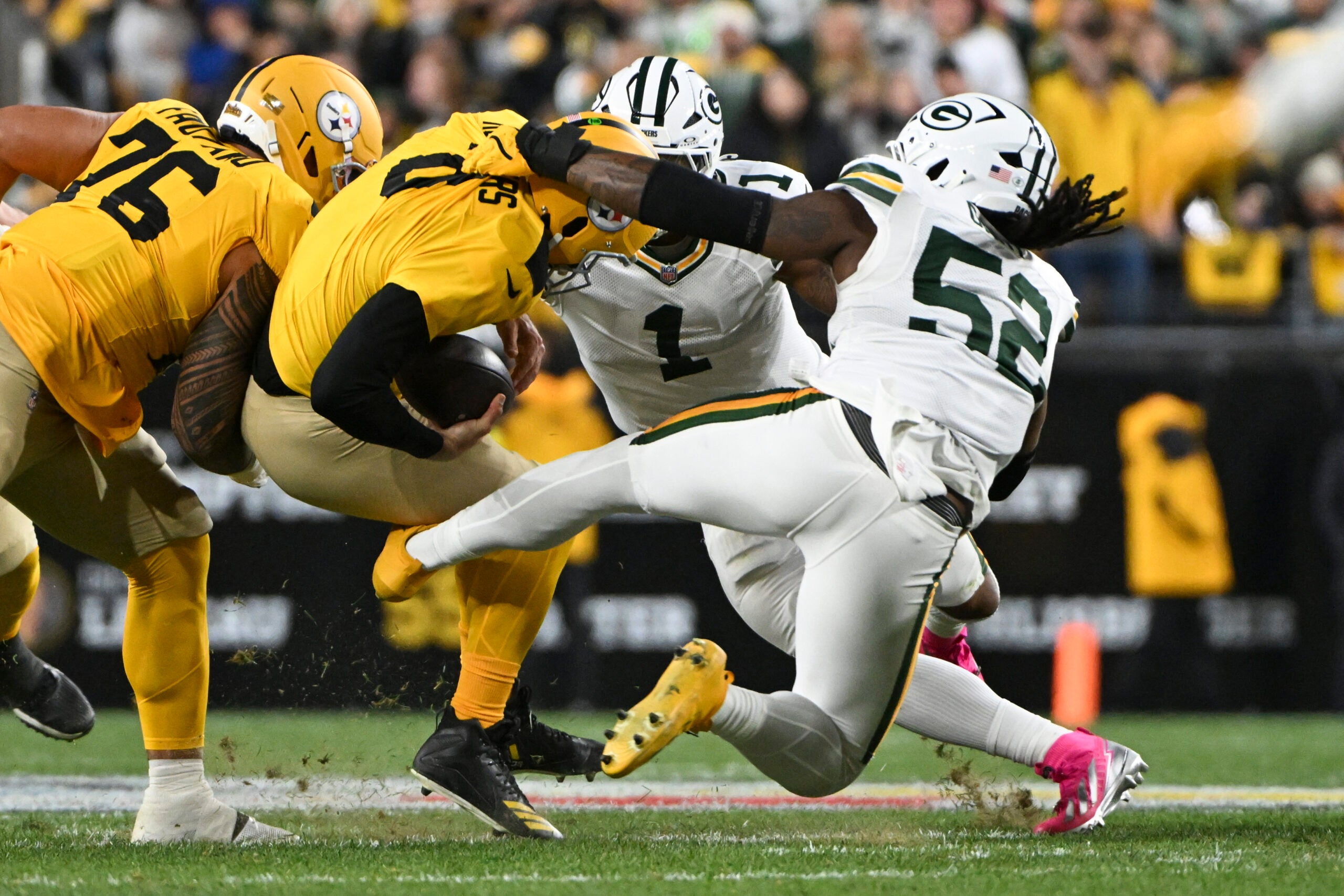 Oct 26, 2025; Pittsburgh, Pennsylvania, USA; Pittsburgh Steelers quarterback Aaron Rodgers (8) is sacked by Green Bay Packers defensive end Rashan Gary (52) during the first quarter at Acrisure Stadium.