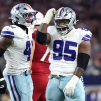 Nov 3, 2025; Arlington, Texas, USA; Dallas Cowboys defensive tackle Kenny Clark (95) and defensive end Donovan Ezeiruaku (41) celebrate after a sack Arizona Cardinals quarterback Jacoby Brissett (7) in the second half at AT&T Stadium.