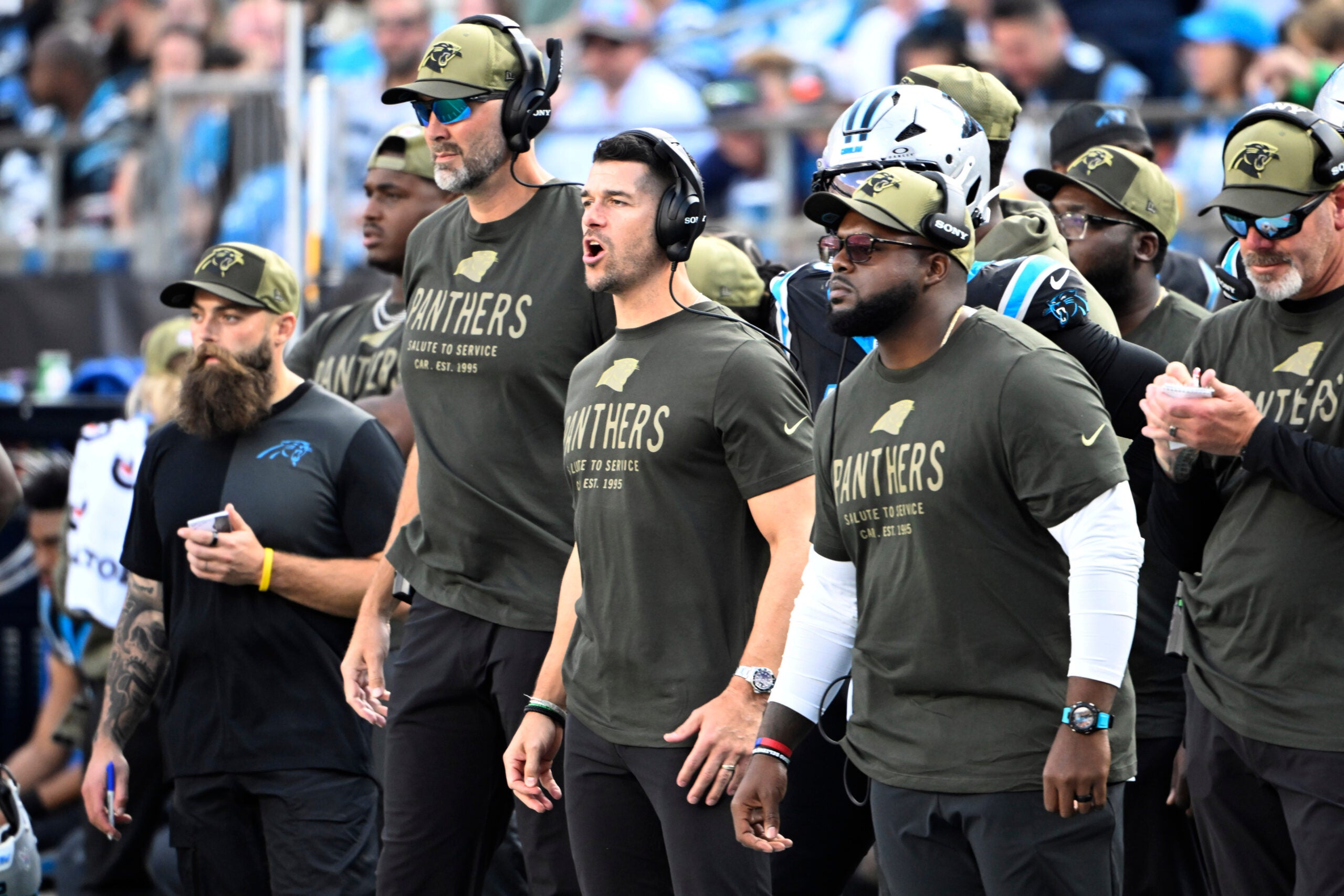 Nov 9, 2025; Charlotte, North Carolina, USA; Carolina Panthers head coach Dave Canales and coaching staff on the sidelines in the third quarter at Bank of America Stadium.