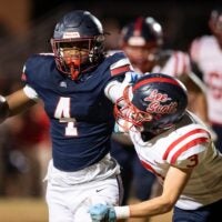 Montgomery Academy's Braden Gordon (4) stiff arms Lee-Scott's Preston Huguley (3) at Montgomery Academy in Montgomery, Ala. on Friday, Nov. 14, 2025. Montgomery Academy leads Lee-Scott 28-0 at halftime.
