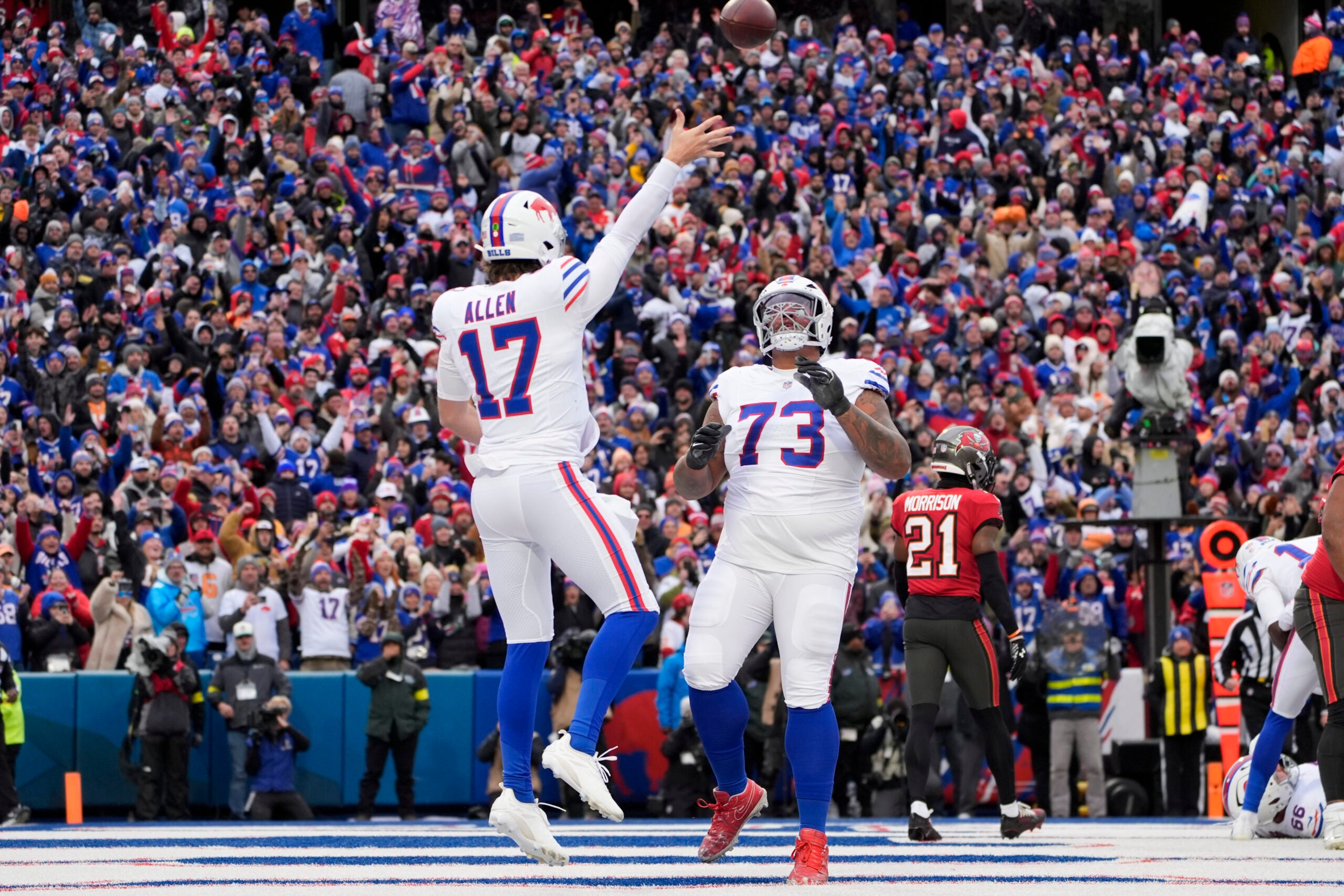 Nov 16, 2025; Orchard Park, New York, USA; Buffalo Bills quarterback Josh Allen (17) celebrates his touchdown against the Tampa Bay Buccaneers with offensive tackle Dion Dawkins (73) during the first quarter of the game at Highmark Stadium.