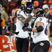 Nov 16, 2025; Cleveland, Ohio, USA; Baltimore Ravens quarterback Lamar Jackson (8) and center Tyler Linderbaum (64) celebrate a touchdown during the fourth quarter against the Cleveland Browns at Huntington Bank Field.