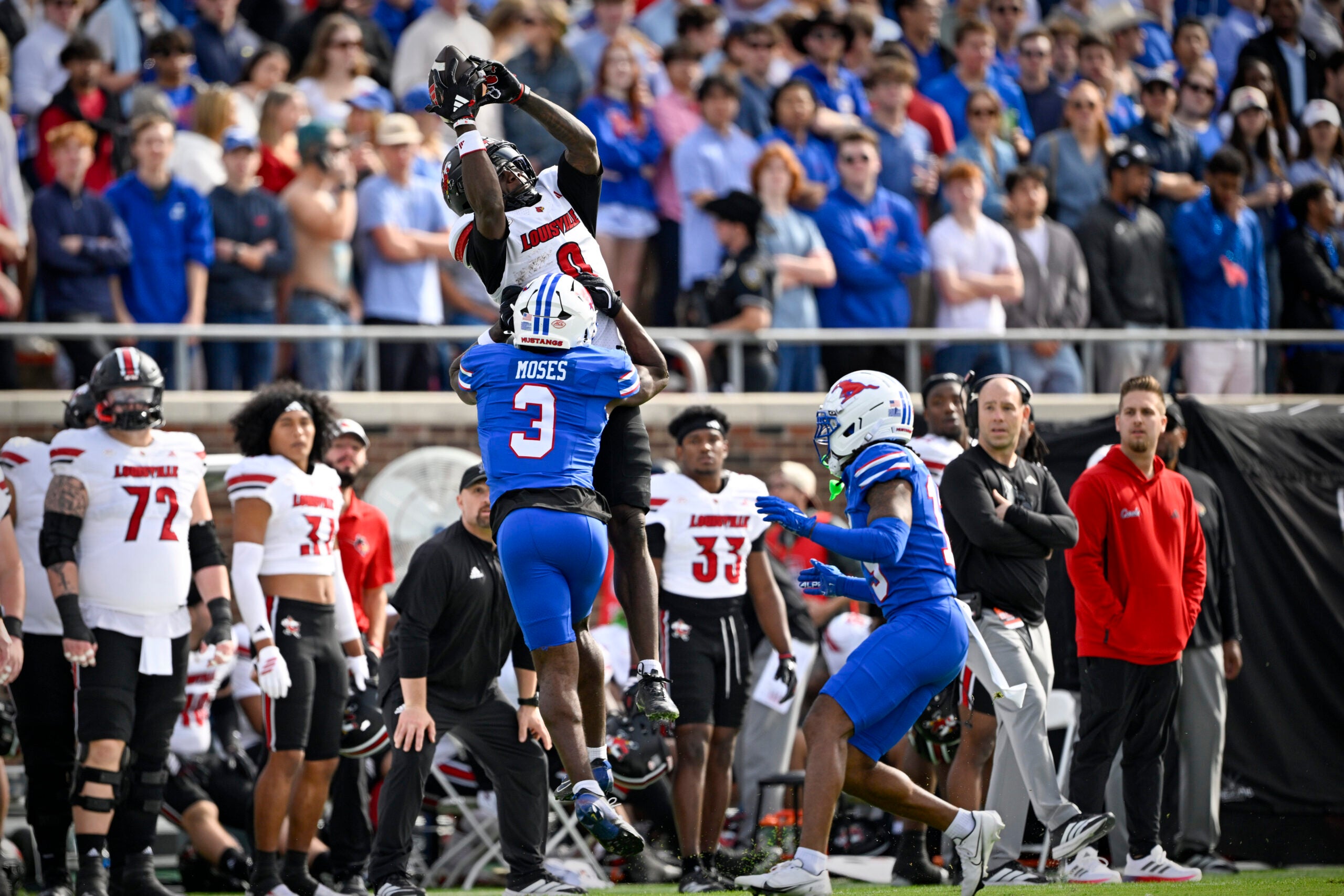 Nov 22, 2025; Dallas, Texas, USA; Louisville Cardinals wide receiver Chris Bell (0) catches a pass over SMU Mustangs safety Ahmaad Moses (3) during the first half at Gerald J. Ford Stadium. Mandatory Credit: Jerome Miron-Imagn Images