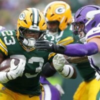 Green Bay Packers running back Emanuel Wilson (23) against the Minnesota Vikings linebacker Blake Cashman (51) on Sunday, November 23, 2025, at Lambeau Field in Green Bay, Wis. The Packers defeated the Vikings 23-6.