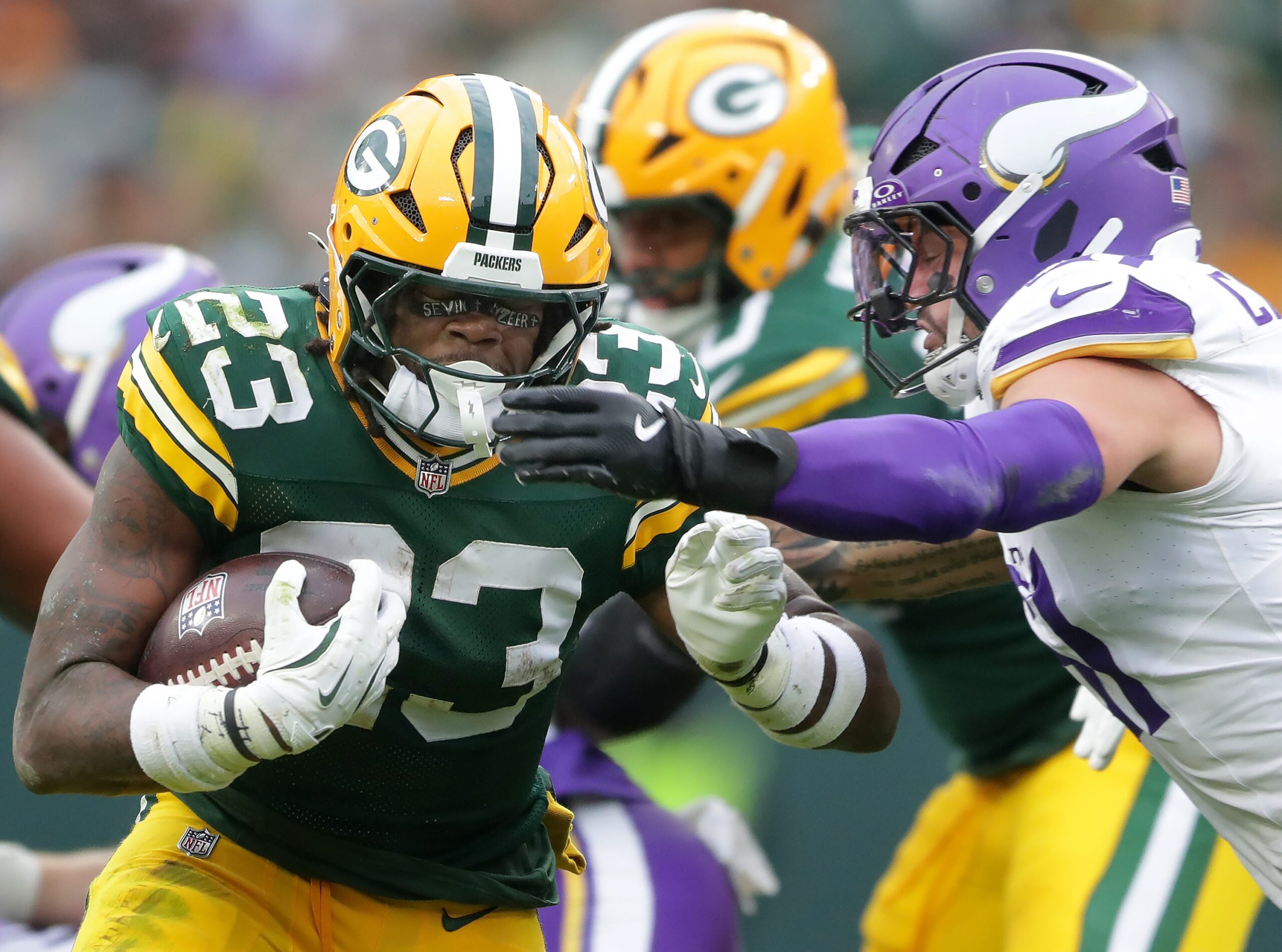 Green Bay Packers running back Emanuel Wilson (23) against the Minnesota Vikings linebacker Blake Cashman (51) on Sunday, November 23, 2025, at Lambeau Field in Green Bay, Wis. The Packers defeated the Vikings 23-6.