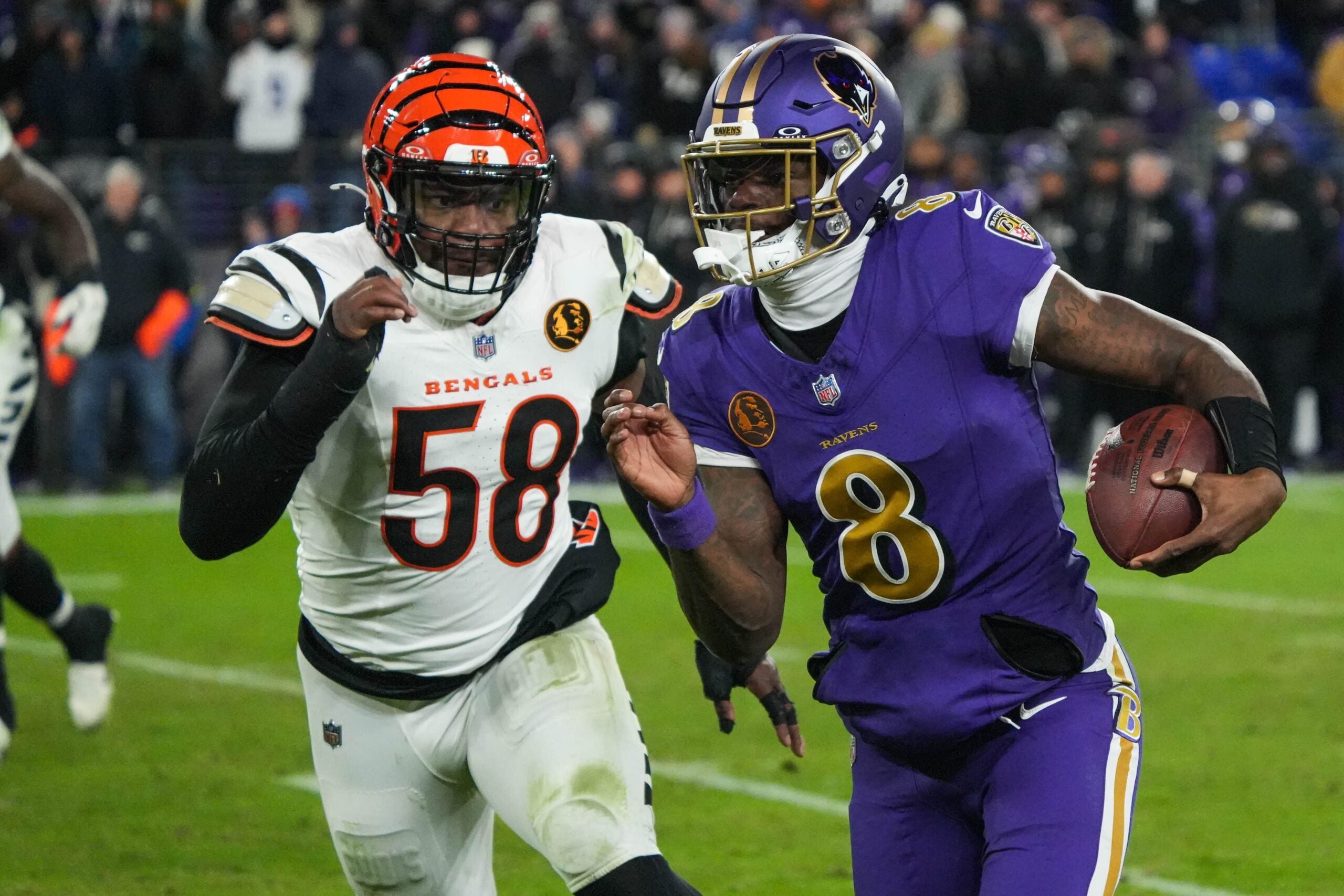 Bengals Joseph Ossai (58) rushes Ravens Lamar Jackson (8) during their game at M&T Bank Stadium on Thanksgiving Thursday November 27, 2025. The Bengals won the game with a final score of 33-14.