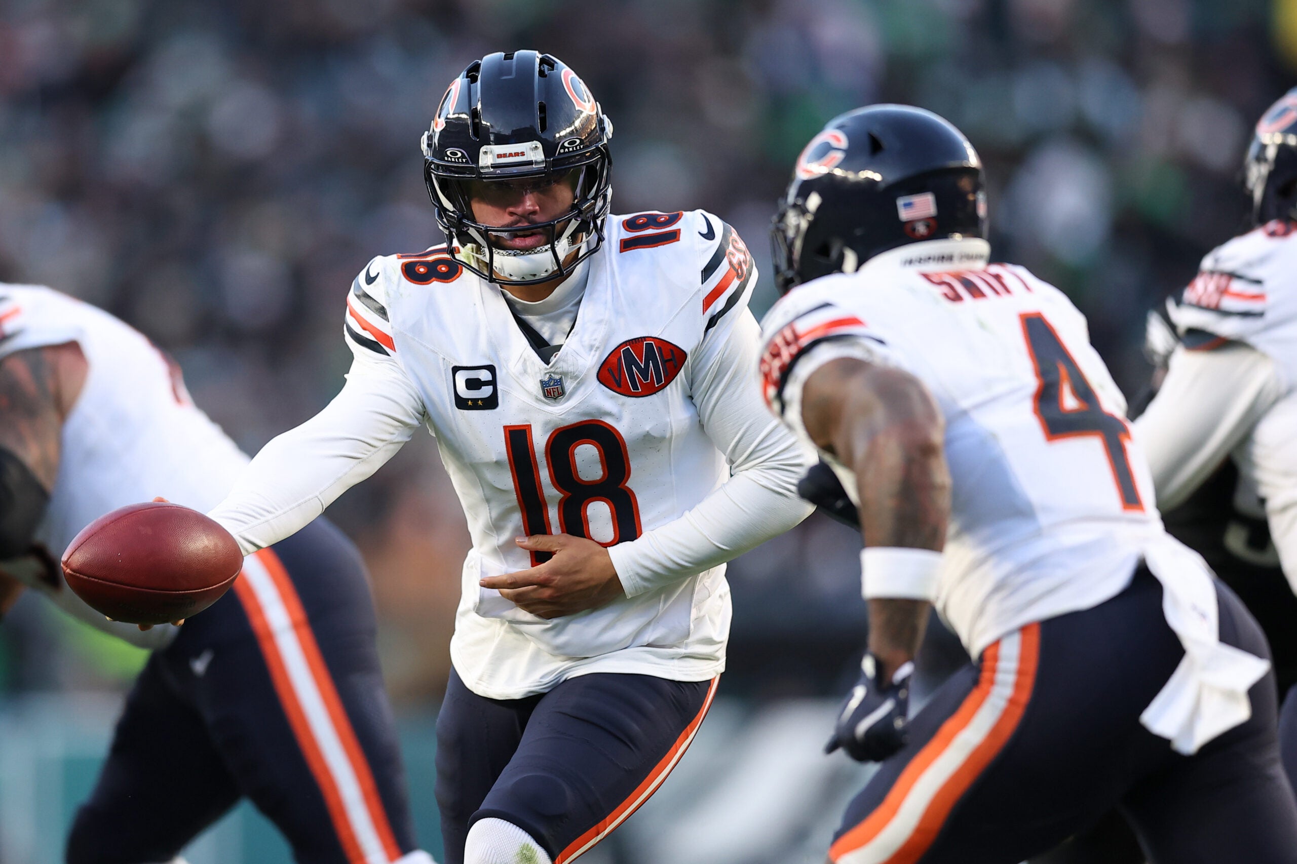 Nov 28, 2025; Philadelphia, Pennsylvania, USA; Chicago Bears quarterback Caleb Williams (18) hands off the ball to Chicago Bears running back D'Andre Swift (4) against the Philadelphia Eagles during the second quarter of the game at Lincoln Financial Field.