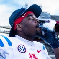 Ole Miss defensive lineman Zxavian Harris (51) smokes a cigar after a college football game between Mississippi State and Ole Miss at Davis Wade Stadium in Starkville, Miss., on Friday, Nov. 28, 2025. Ole Miss defeated Mississippi State 38-19 in the Egg Bowl.