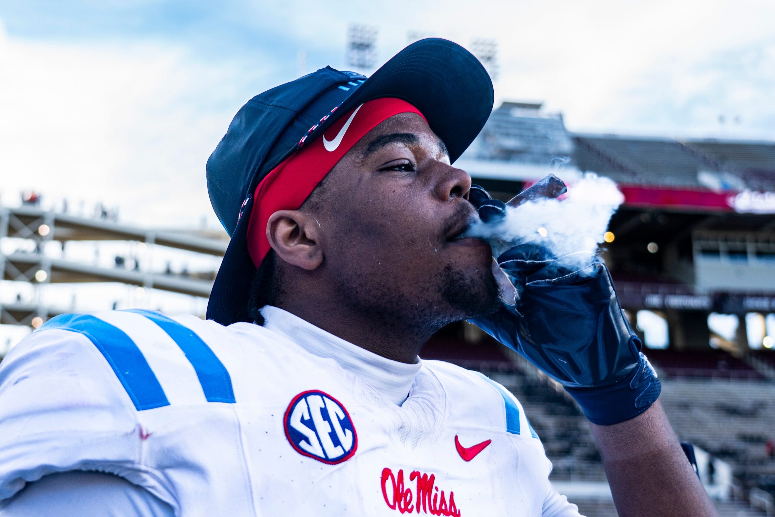 Ole Miss defensive lineman Zxavian Harris (51) smokes a cigar after a college football game between Mississippi State and Ole Miss at Davis Wade Stadium in Starkville, Miss., on Friday, Nov. 28, 2025. Ole Miss defeated Mississippi State 38-19 in the Egg Bowl.