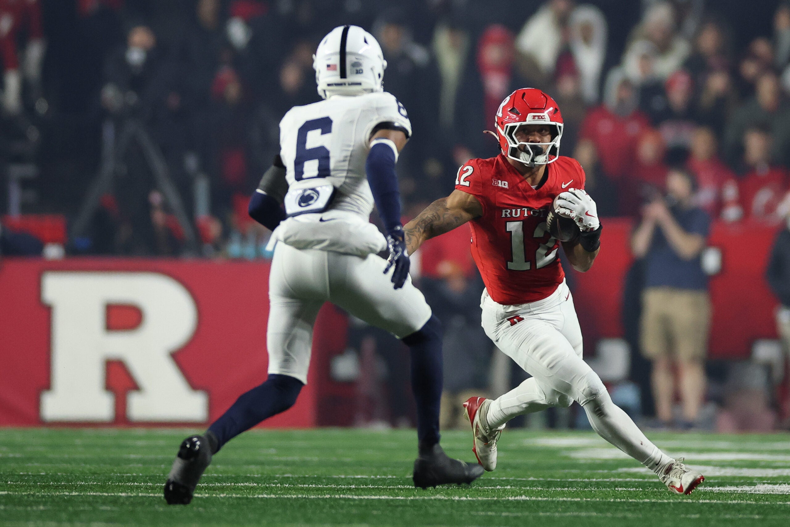 Nov 29, 2025; Piscataway, New Jersey, USA; Rutgers Scarlet Knights tight end Kenny Fletcher Jr. (12) gains yards after catch as Penn State Nittany Lions safety Zakee Wheatley (6) pursues during the second half at SHI Stadium.